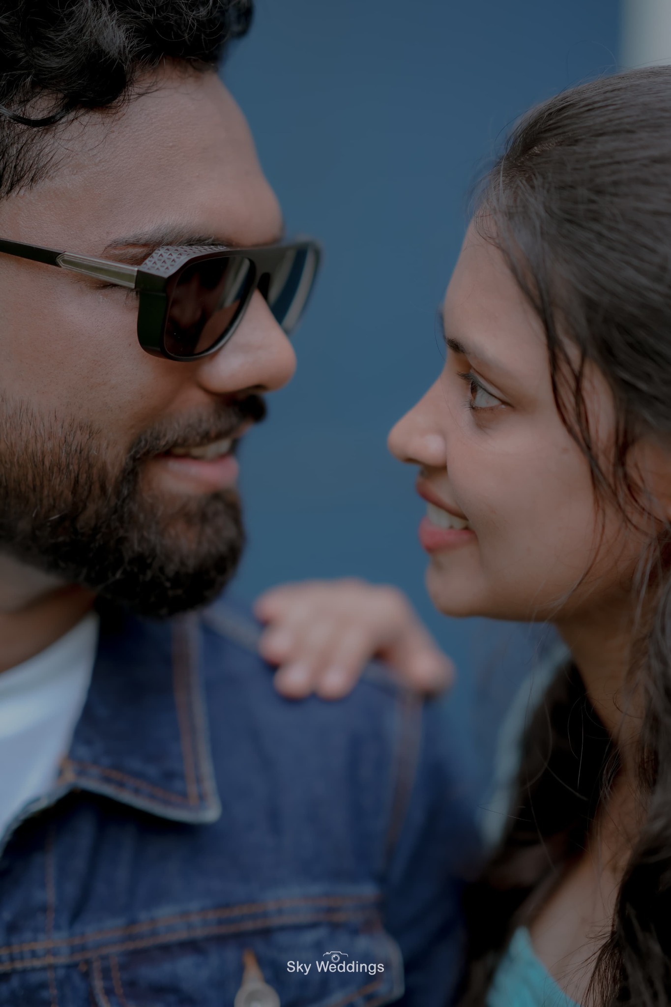 Smiling close‑up looking into each other’s eyes